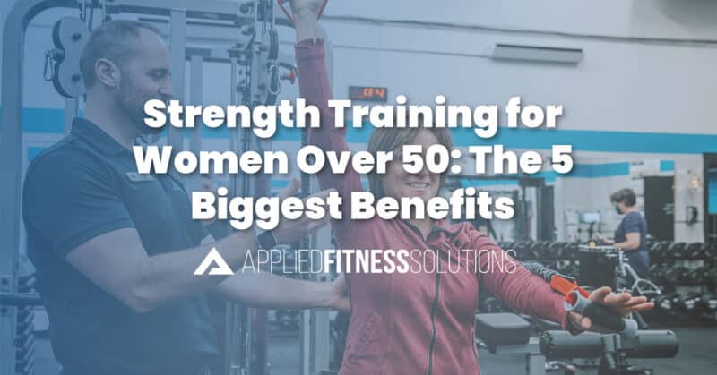 Woman doing resistance training together with an exercise physiologist in a strength training class at Applied Fitness Solutions in Ann Arbor.